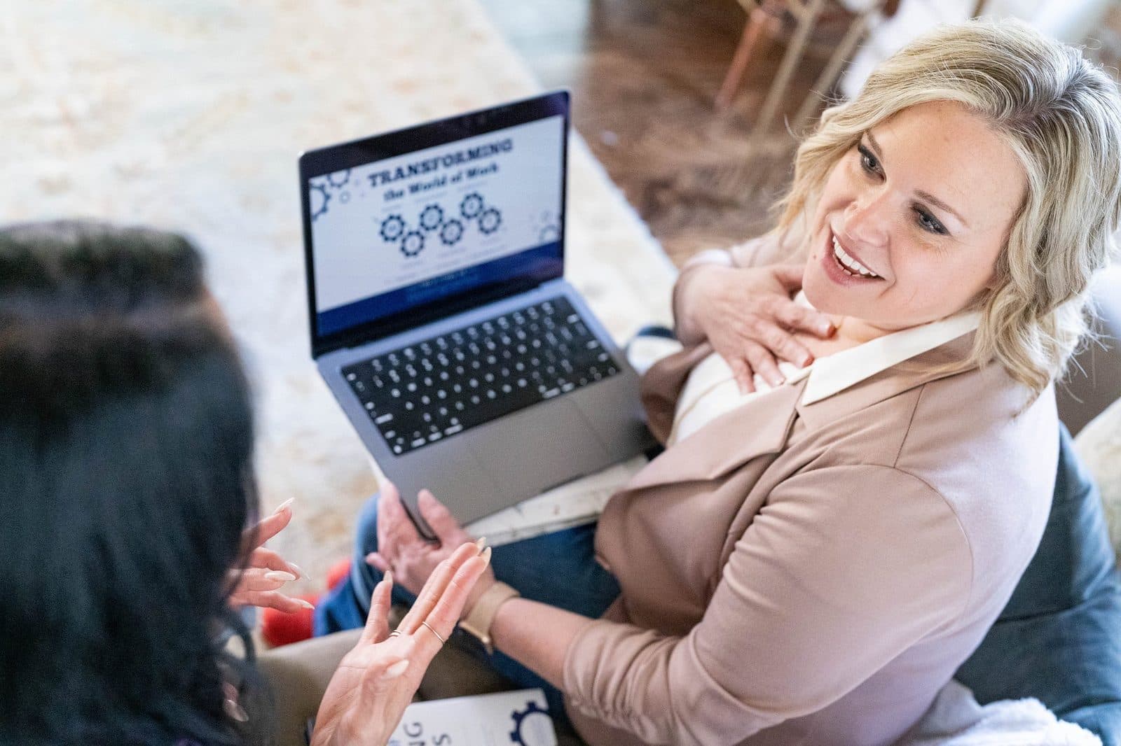 Janna Hubert consulting with a small business owner over a laptop